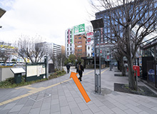 After going down the escalator, follow the road and go across the crosswalk.